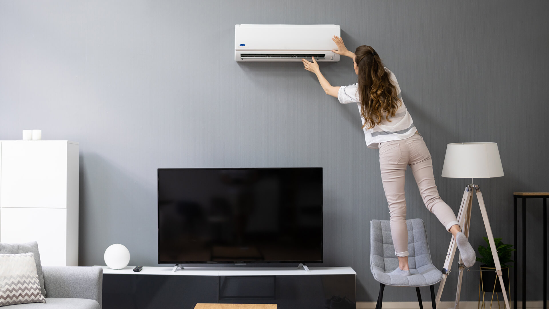lady-about-to-remove-carrier-split-type-aircon-filter-in-the-living-room-carrier-philippines-blog